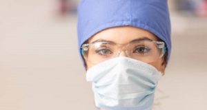 Portrait of female doctor in special surgical sterile protective clothing.