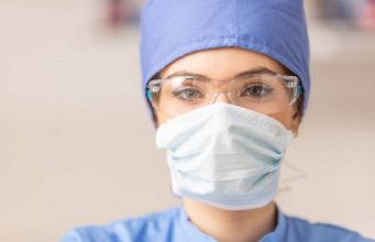 Portrait of female doctor in special surgical sterile protective clothing.