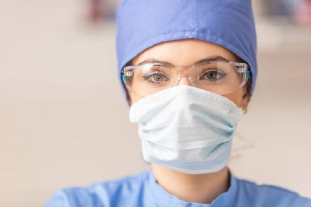 Portrait of female doctor in special surgical sterile protective clothing.